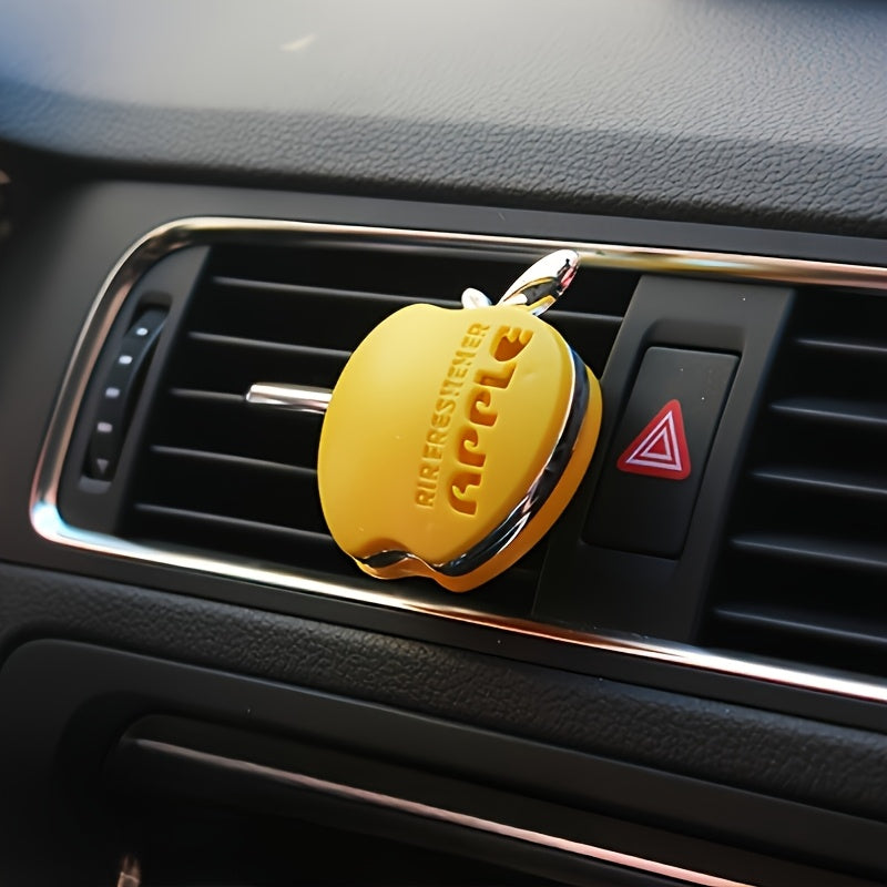 Apple-shaped car air freshener with aromatherapy perfume diffuser and vent clip fragrance dispenser. Includes balm/tablet/incense stick for portable auto scent enhancement.