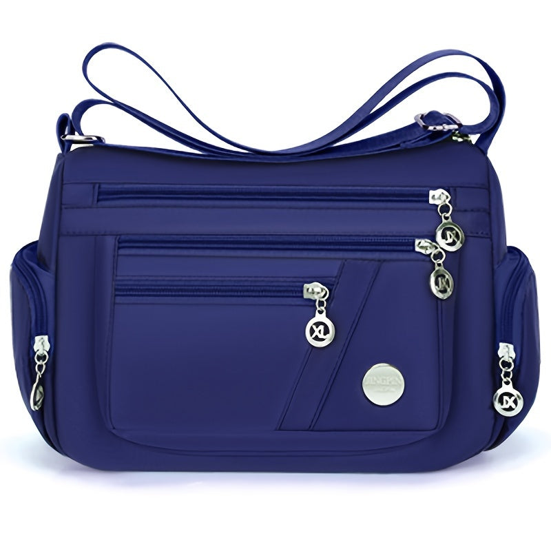 Stylish waterproof nylon crossbody bag with adjustable strap and multi-layer design, ideal for daily commute and travel.