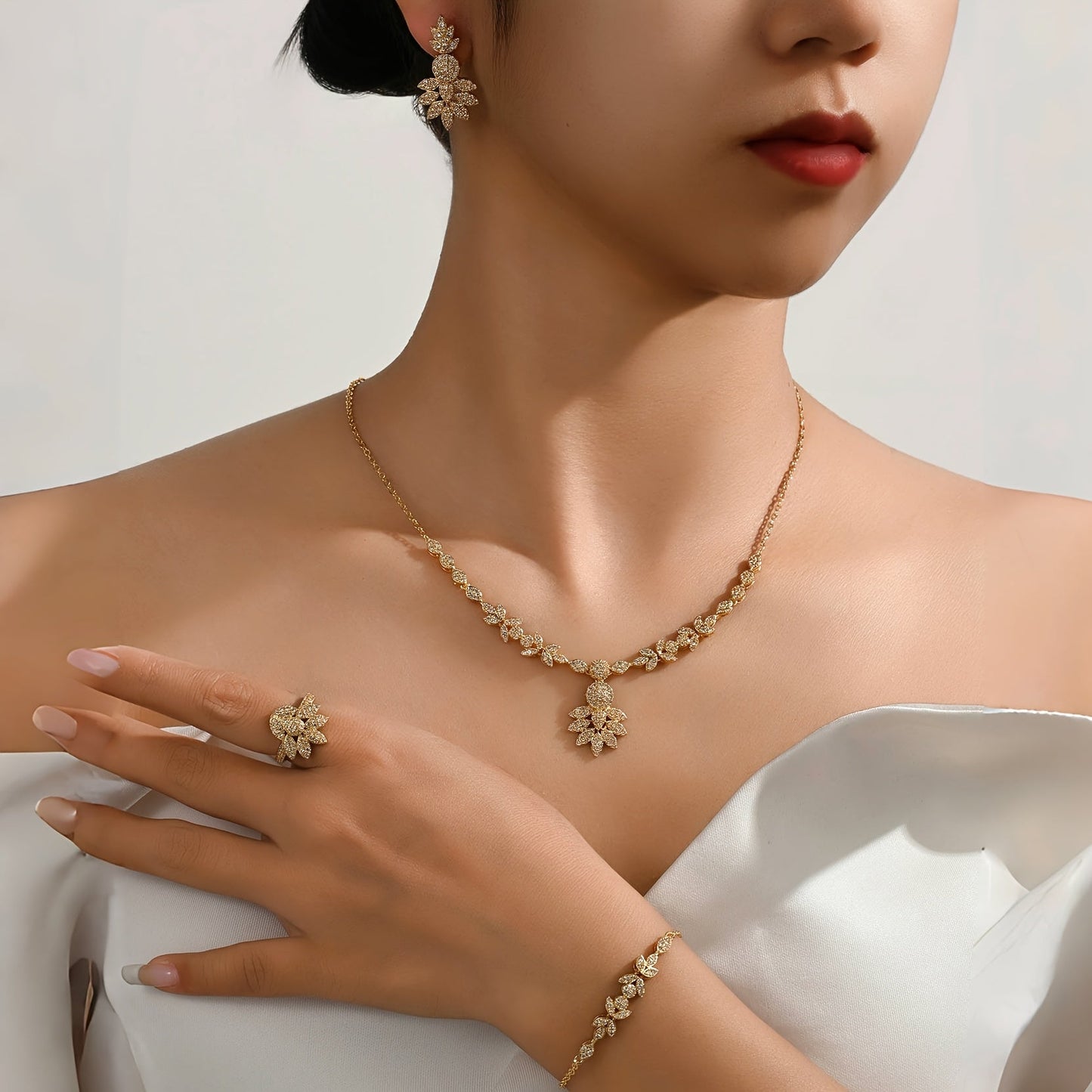 Luxurious 5-piece Jewelry Set for Women, Featuring 18K Gold-Plated Copper adorned with Synthetic Zirconia Stones in a Stunning Floral Design. Includes Necklace, Earrings, Bracelet, and Ring, Perfect for Everyday Wear or Special Wedding Occasions.