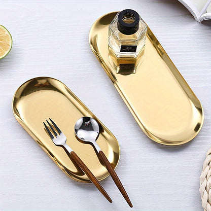 Golden-finish stainless steel oval tray - Minimalist design, durable and easy to clean. Ideal for serving bread, desserts, and snacks in stylish table settings.