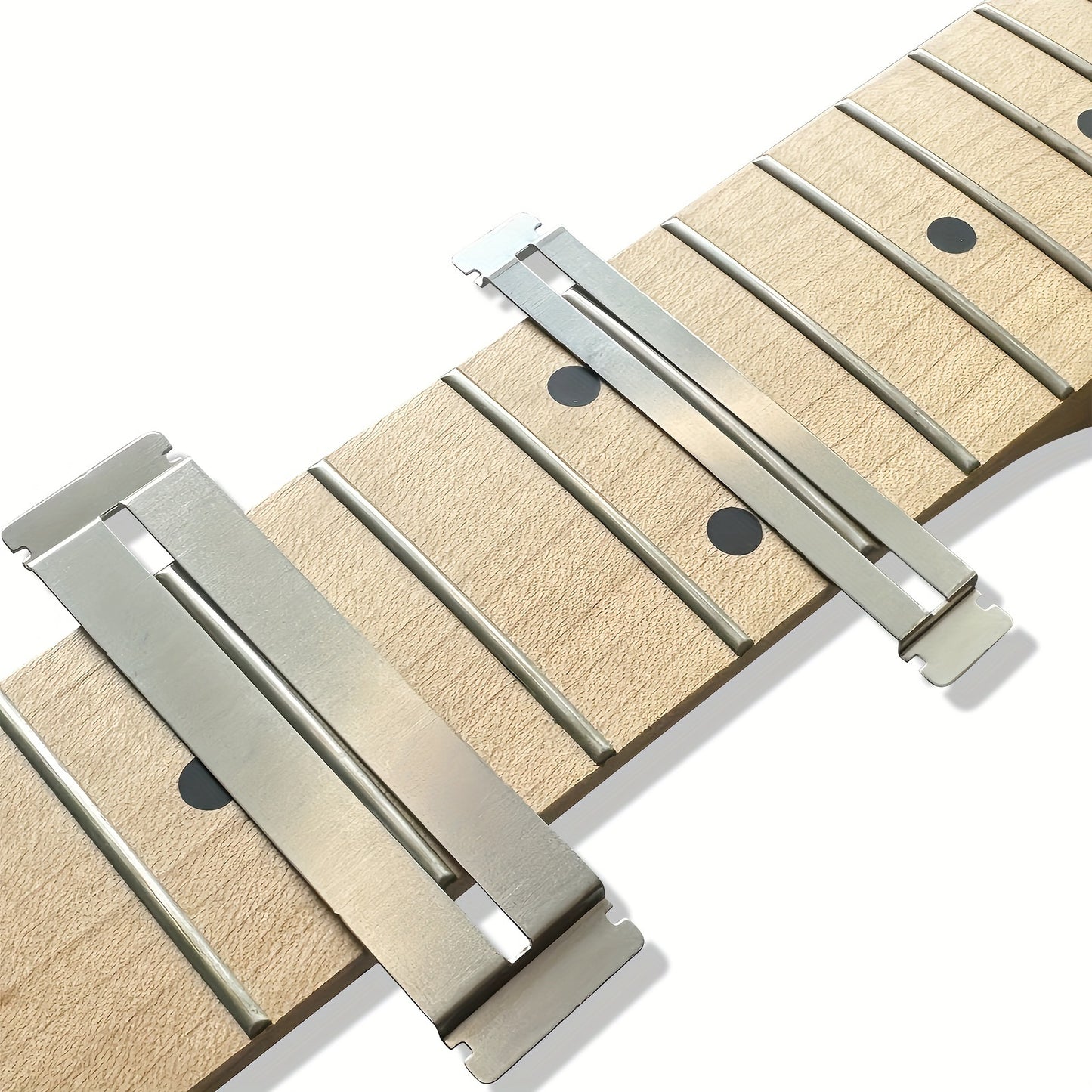 Guitar fretboard maintenance kit with metal protector and grey dressing stones for various string instruments.