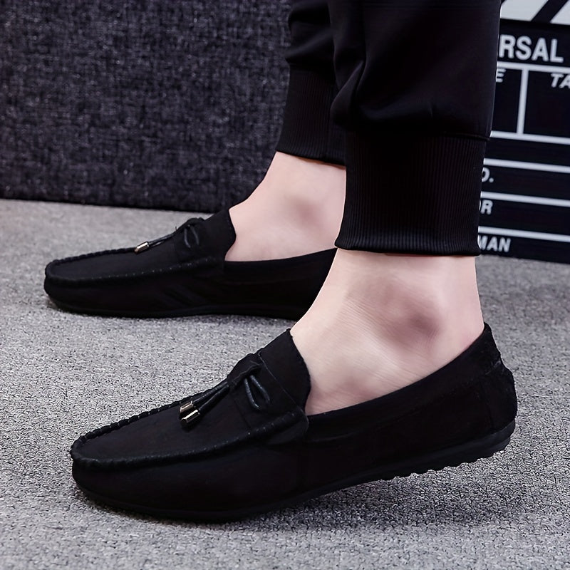 Men's black canvas slip-on loafers with tassel detail, rubber sole, and fabric lining for all seasons. Chic and comfortable canvas shoes.