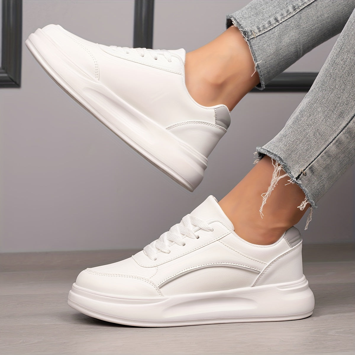 Women's white skate shoes with round toe, lace up closure, and low top flat design. Comfortable for casual wear and sports.