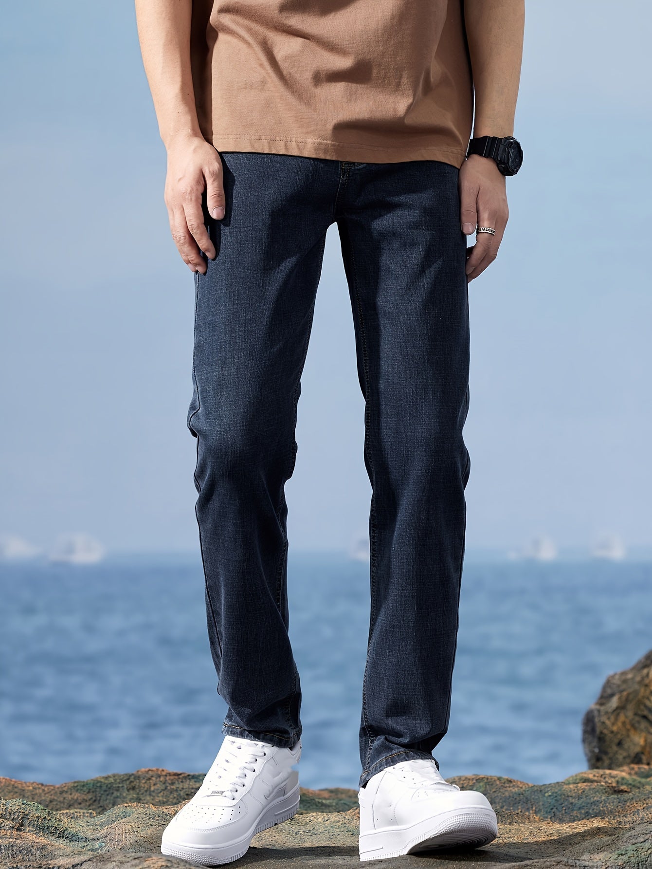 Solid loose denim trousers with pockets for men, made from breathable cotton blend. Perfect for outdoor activities.