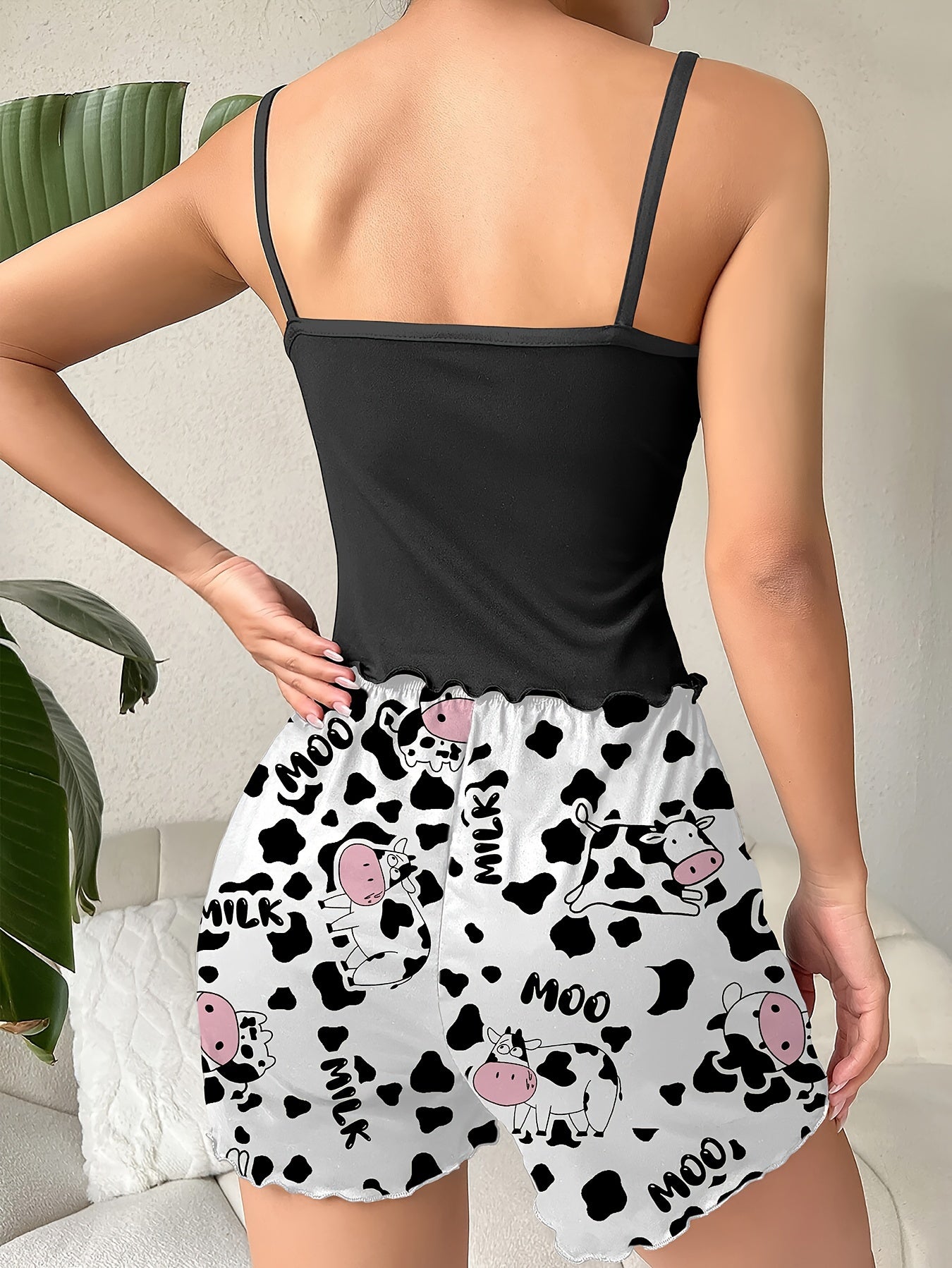 Cow print lounge set including a backless cami top and elastic shorts for women.