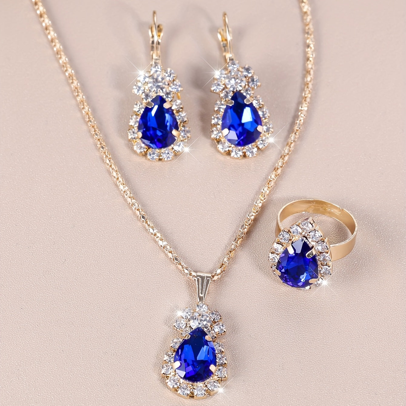 Complete your look with this elegant jewelry set featuring 4 pieces - earrings, necklace, and ring. Made with 18k gold plating and inlaid with shimmering zirconia in multiple colors to suit your style. Perfect for daily wear or adding a touch of glamour