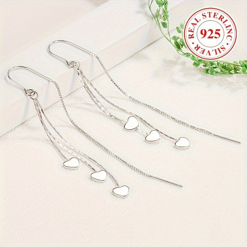 Elegant and simple, these glossy heart chain tassel dangle earrings are made of hypoallergenic sterling silver (925). The perfect delicate gift for a female, they will add a touch of elegance to any outfit.