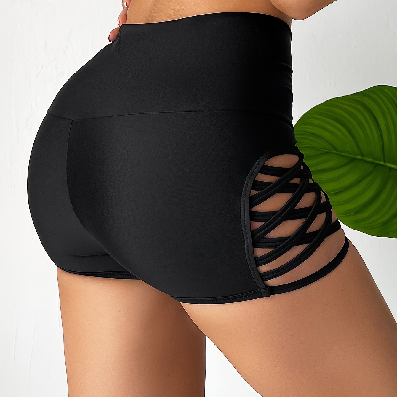 Women's high waist black boxer shorts with cut-out sides, perfect for beachwear.