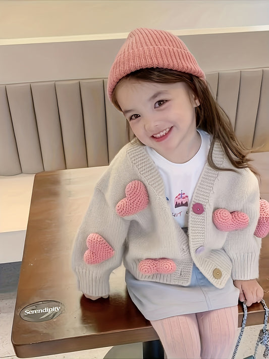 Girl's cozy V-neck sweater with adorable heart pattern, ideal for spring and fall.