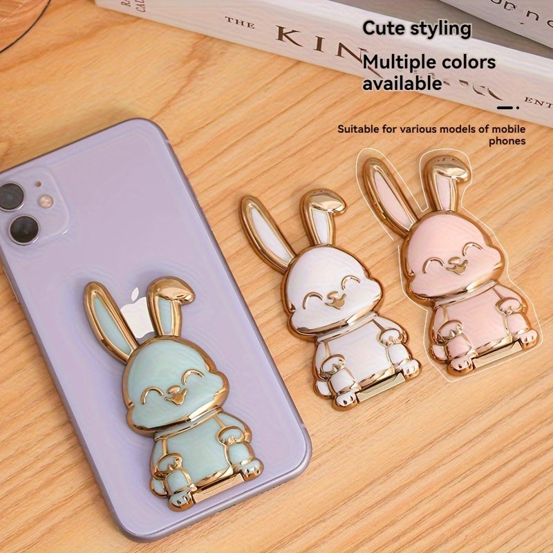 Foldable waterproof phone stand made of ABS material, featuring an adjustable cartoon bunny design for holding smartphones and tablets.