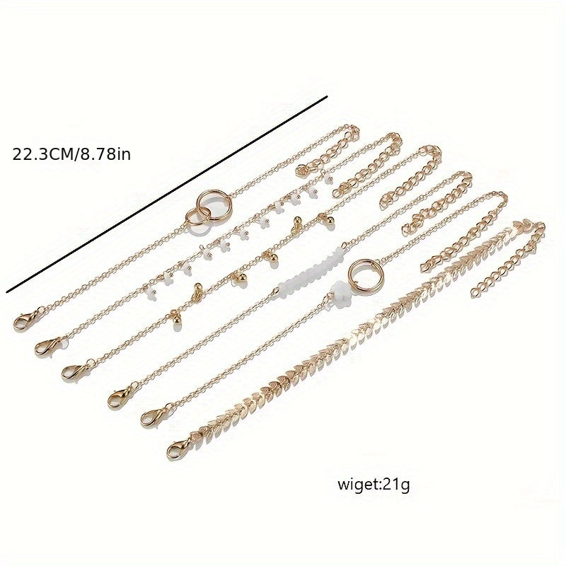 6-piece fashionable retro anklet with layered flower, tassel, tree leaf, and geometric pendants in gold, for girls to wear at daily parties or festivals.