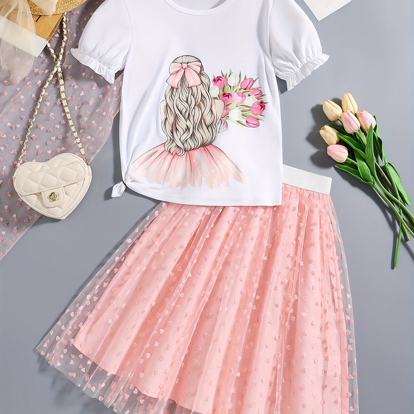 2-piece set featuring a cartoon graphic t-shirt and tutu skirt for girls, perfect for summer outdoor parties. Great as a gift.