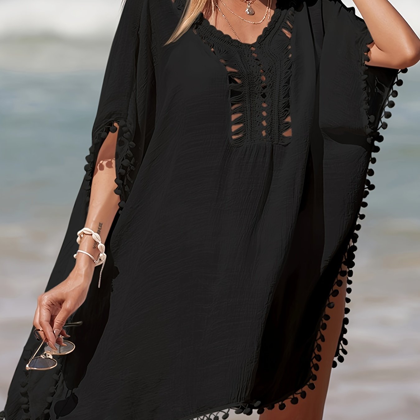 Bohemian style crochet cover up with batwing sleeves, side split, and sheer fabric for beach sun protection.