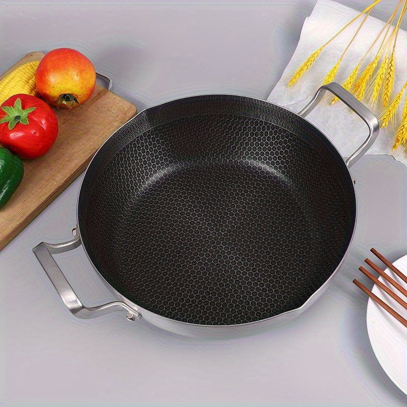 The 10-inch stainless steel frying pan comes with a lid and features a honeycomb non-stick bottom. It is induction compatible and has dual handles, making it versatile for use in various cooking methods such as hot pot and frying.