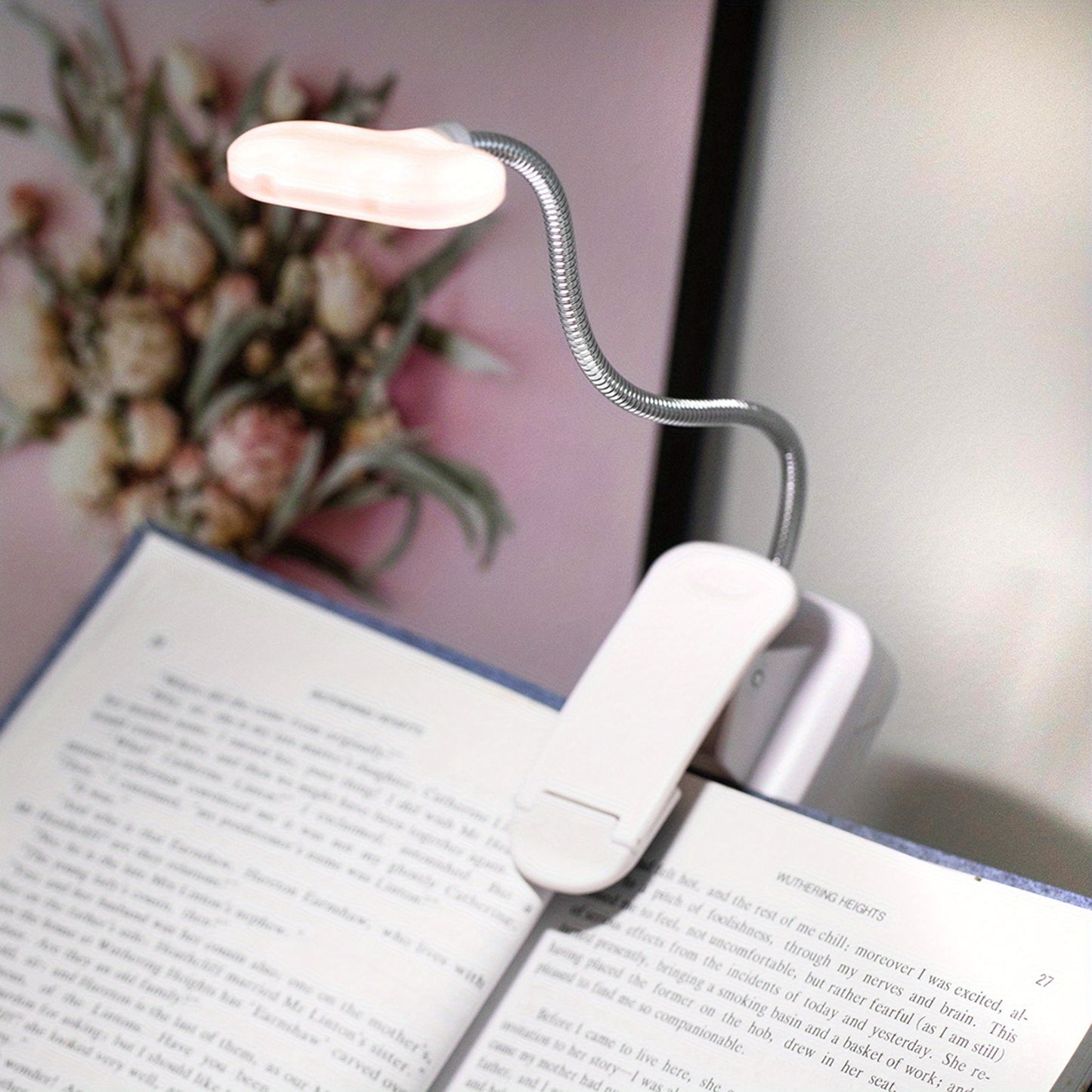 Portable battery-powered clip-on book light for reading that can also be used as a small table lamp or night light for room decor.