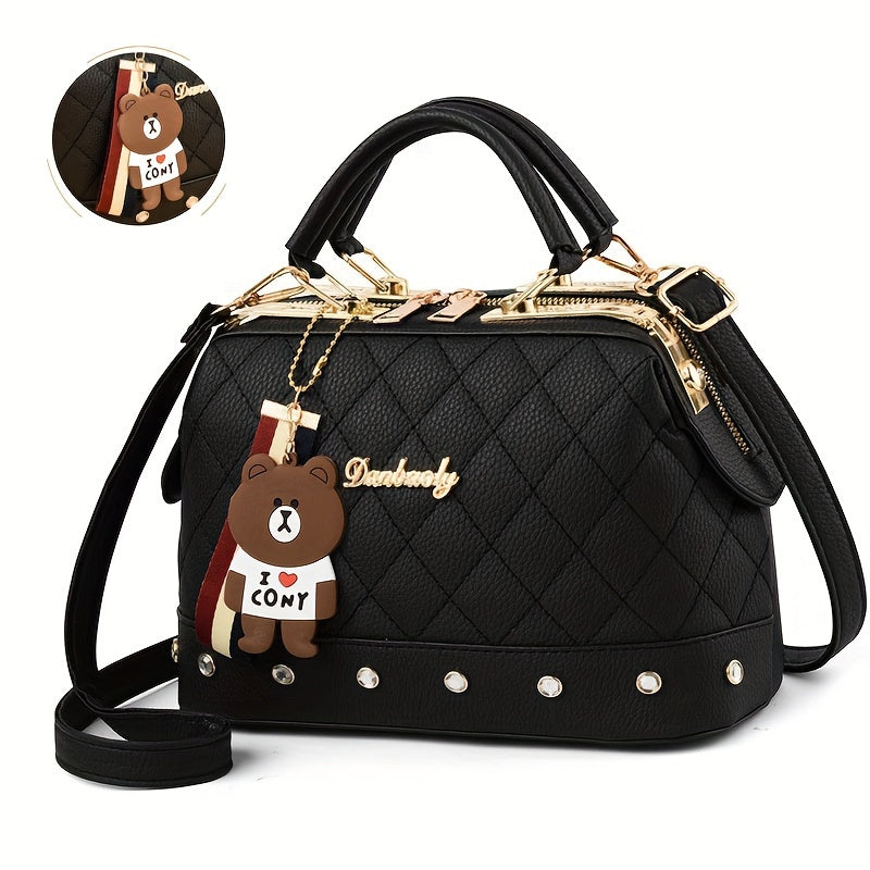 Stylish black shoulder bag for women with cute bear charm, detachable strap, zip closure, and quilted texture - ideal for travel and shopping.