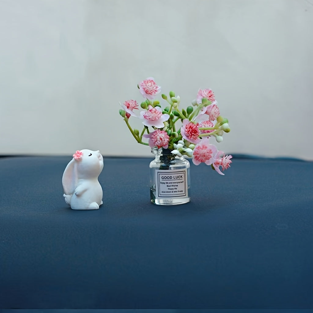 Miniature resin vase for car dashboard décor with healing figurine.