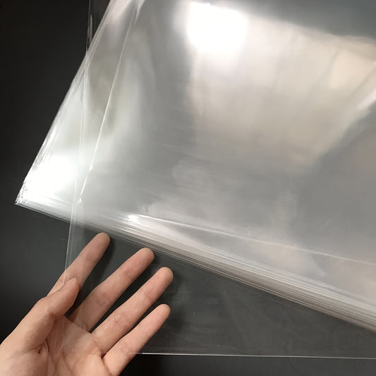 50/100 transparent plastic LP record sleeves for vinyl albums, uncharged protective covers. Single and double sleeve set with additional plastic material.