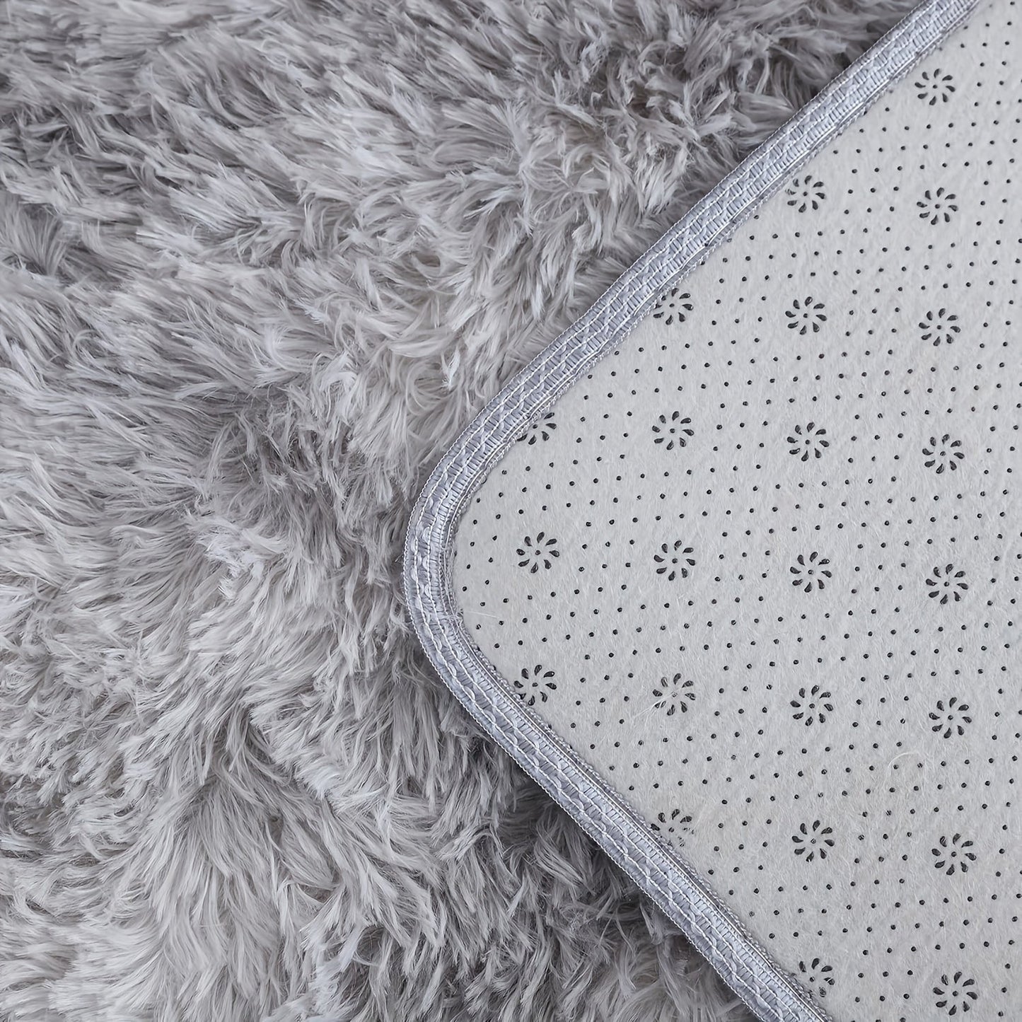 This cozy round area rug is perfect for adding a touch of softness to any room. Made with plush faux fur and lightweight knit polyester fiber, this super fluffy round mat has a rubber backing for extra durability. With a low pile and machine-made