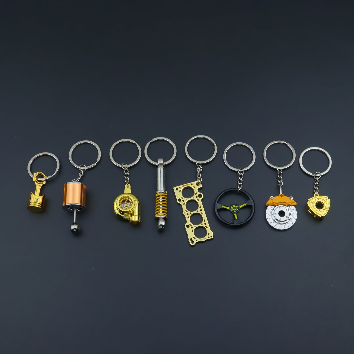 Keychains for creative car modifications, including piston, brake disc, gear, turbocharger, small rotor, shock absorber, engine blade, and steering wheel designs. Perfect for car enthusiasts and as a unique gift.