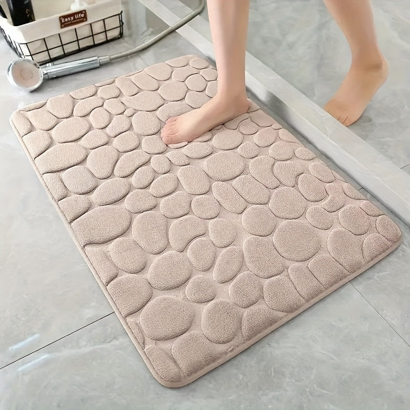 Soft, non-slip coral fleece bathroom mat in a pebble pattern. Quick-dry, machine washable, and low pile for comfort and home decor. Made of plush polyester fiber with knit fabric and 100% polyester material. 570gsm and 1.4cm thick.