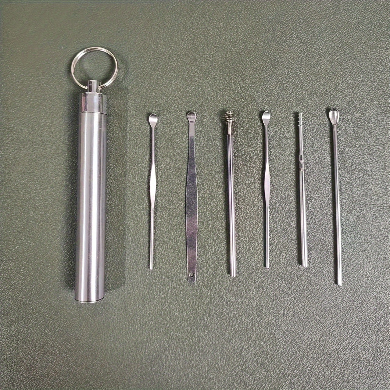 Set of 6 stainless steel ear cleaning tools with spiral and cylindrical designs, portable keychain set for household use.