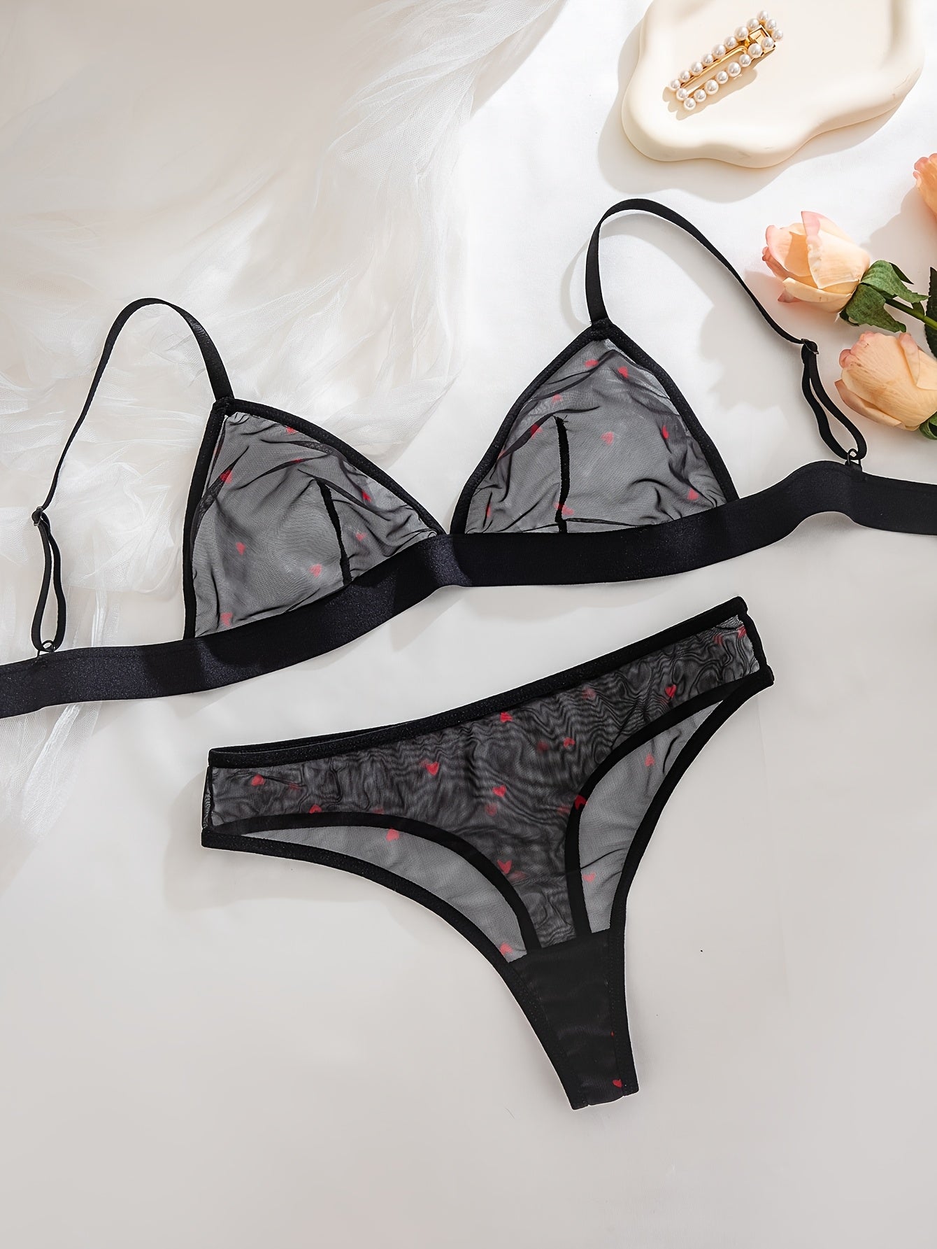 Black sheer mesh lingerie set with red heart pattern, polyester-elastane blend, no underwire, drop waist, part of adult collection.