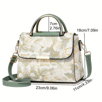 Large capacity floral embroidered crossbody bag with zipper closure and polyester lining. Versatile commuter handbag with luxurious, fashionable design and edge paint detail. Available in