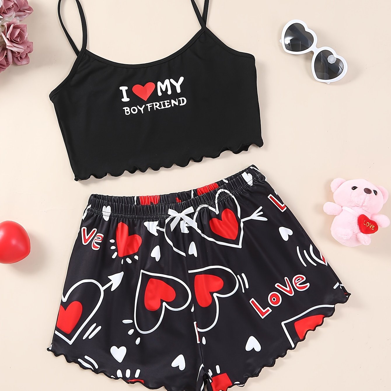 Valentine's Day pajama set for women, featuring heart and slogan print cami top with lettuce trim crew neck and elastic shorts.