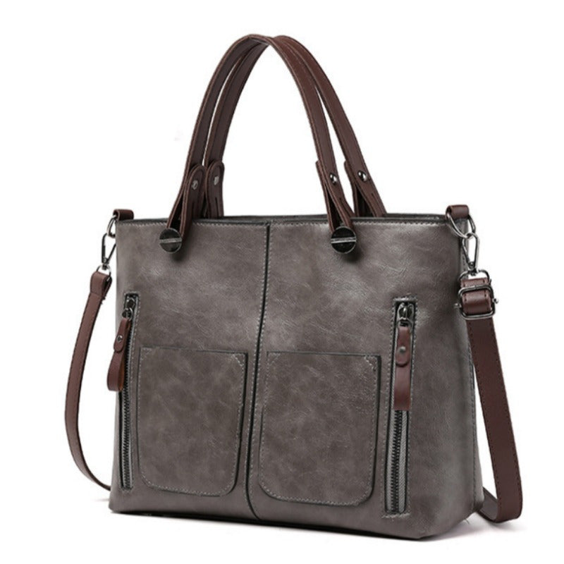 Vintage-style women's tote bag with adjustable strap, large capacity, multiple pockets, zipper closure, deep brown.