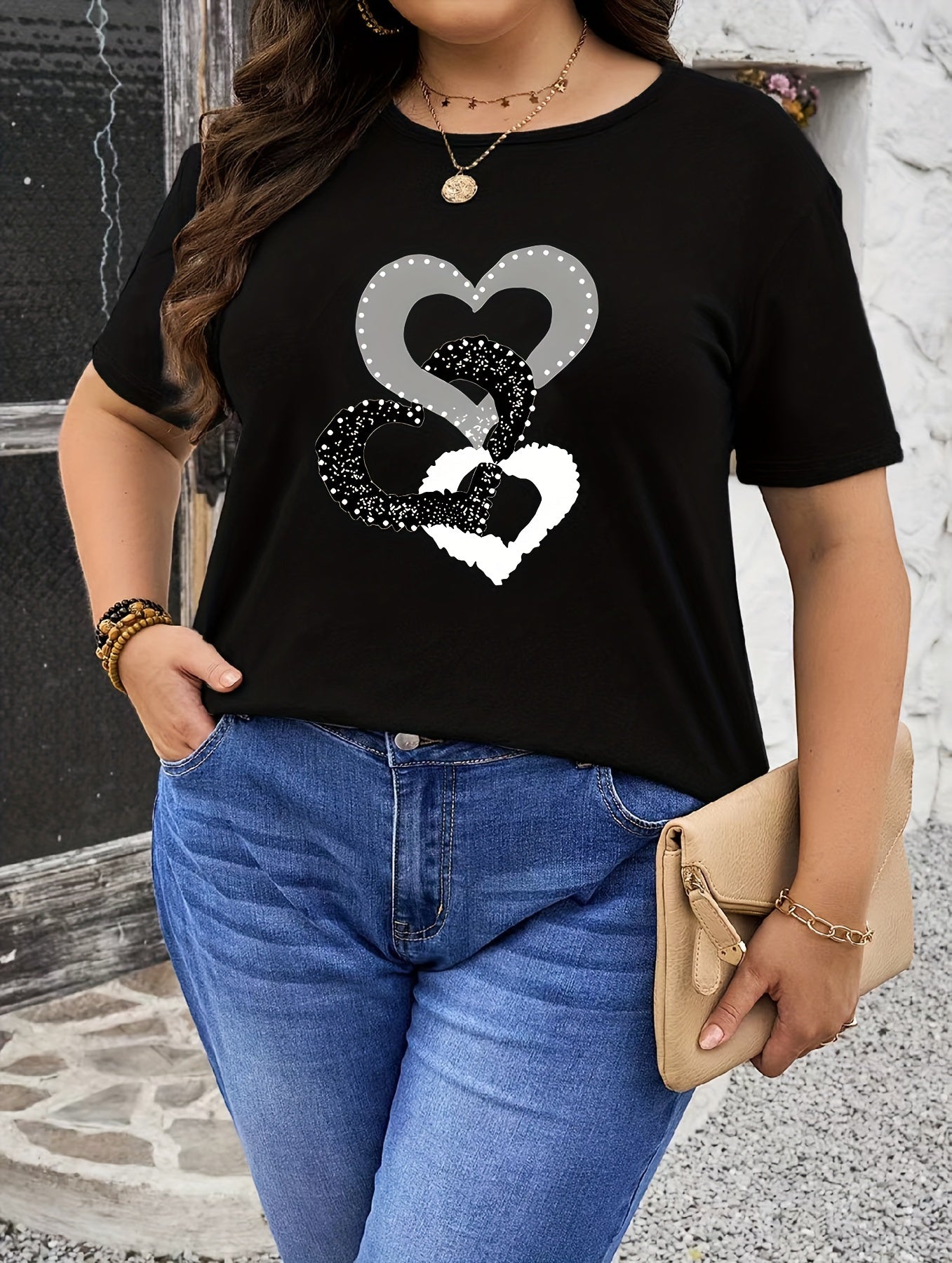 Black heart graphic tee in plus size, soft touch, chic design, crew neck, short sleeve, stretchy polyester blend, machine washable.