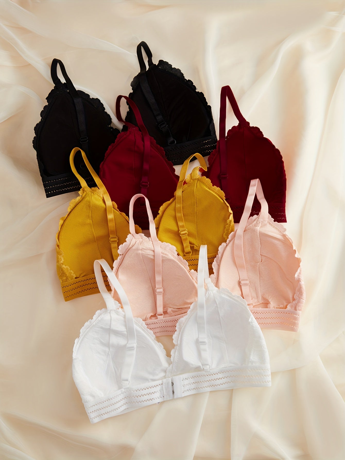 5 Lace-Trimmed wireless bras for women made of comfortable nylon blend. Full coverage with removable pads, non-see-through. Available in black, maroon, yellow, white, and pink. Elegant and