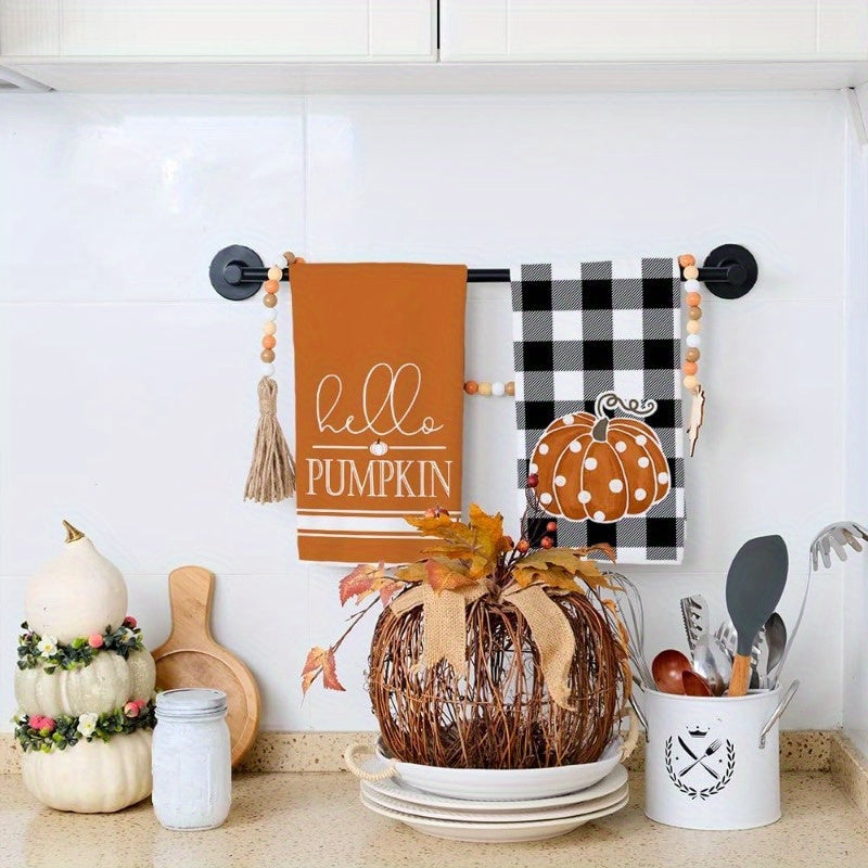 Set of 2 kitchen towels measuring 45.72*66.04 cm featuring autumn pumpkin elements for home decor. These reusable towels are perfect for parties, holiday decorations, and make a great gift. The design includes a black buffalo plaid polka dot pumpkin