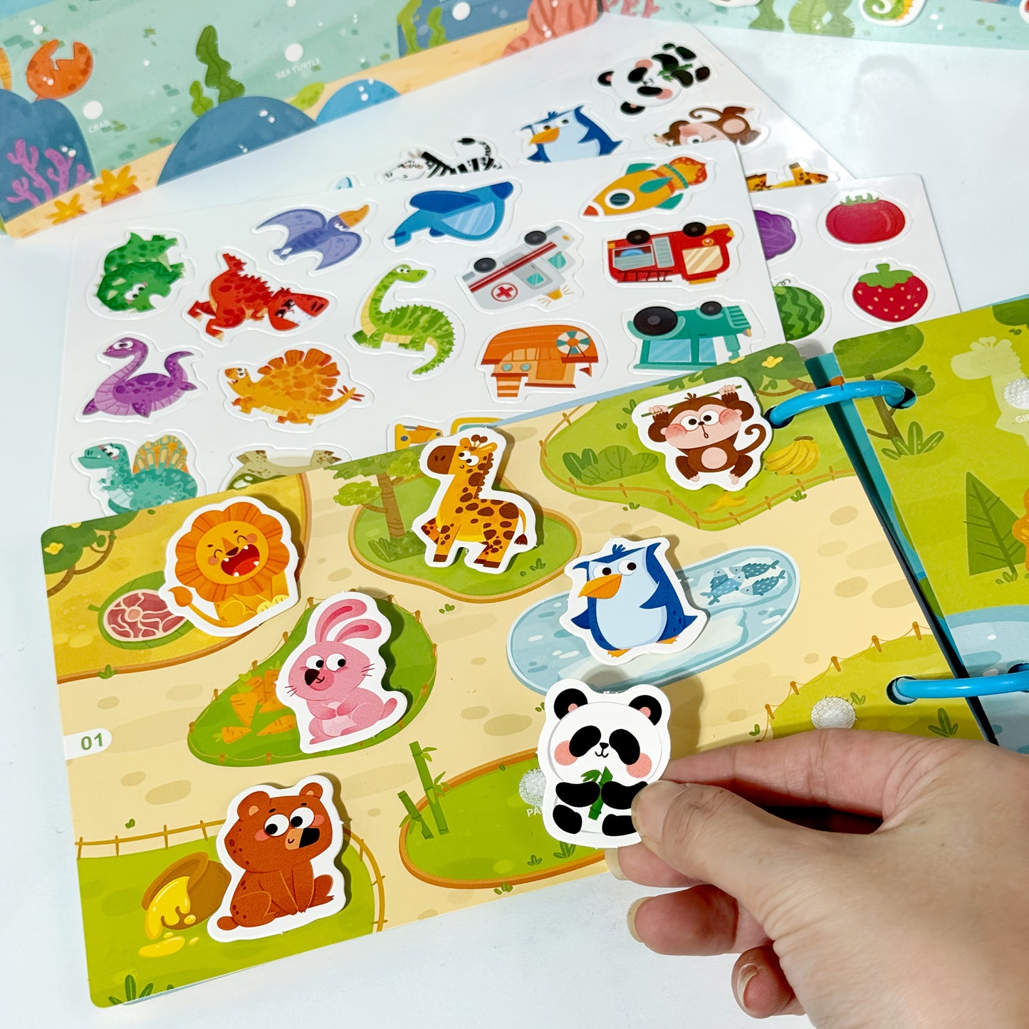 Reusable sticker book with quiet activities focusing on dinosaurs, fruits, animals, oceans, and transportation to improve cognitive, logical, and sensory skills through hands-on DIY tasks.