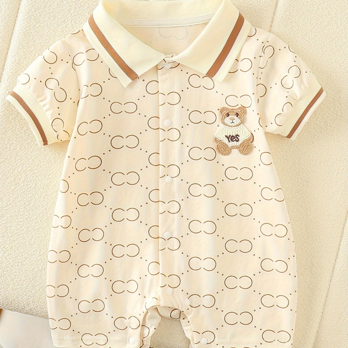 Cute bear-themed cotton romper for baby girls, perfect for summer outdoor wear, with short sleeves and a mechanical collar.