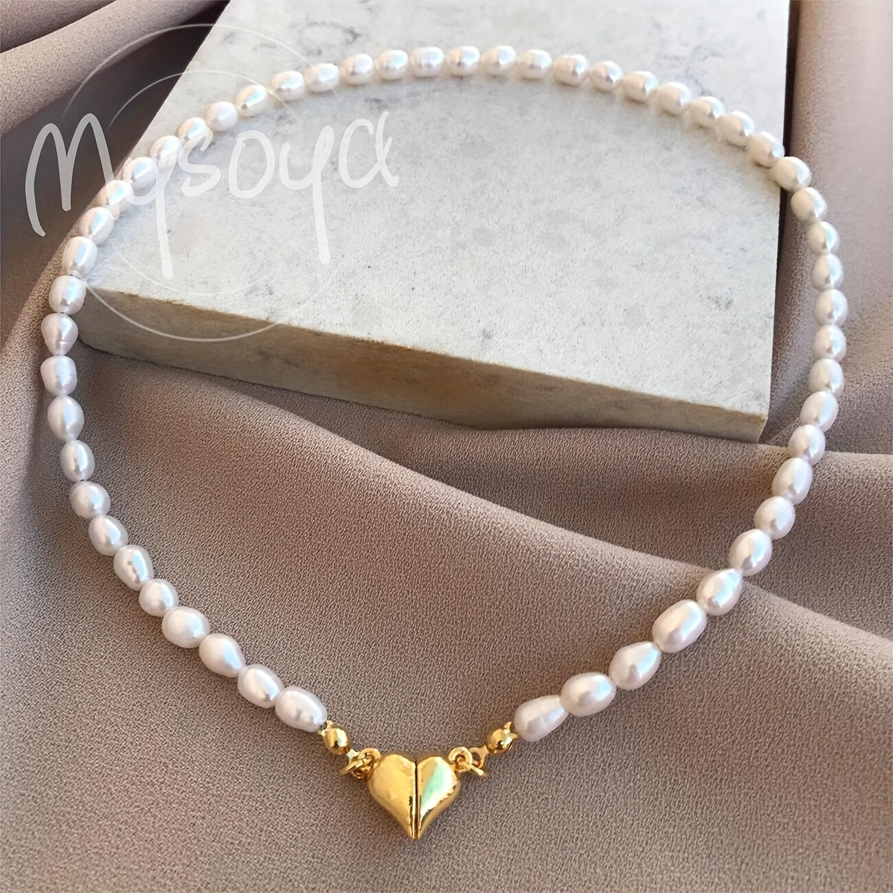 MYSOYA presents a stunning handmade necklace featuring natural freshwater rice-shaped pearls, adorned with a golden or silvery heart. The 6-7mm pearls come beautifully packaged in a gift box, making it a perfect jewelry gift for him or her. Ideal for