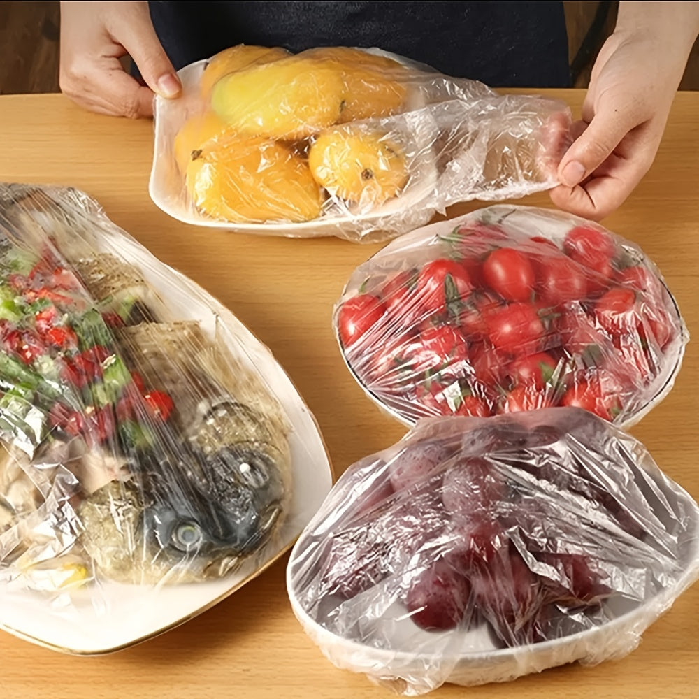 50-100 pieces of disposable fresh-keeping covers made of plastic for use in storing food. These covers are elastic and can be used to cover various storage containers in the kitchen or outdoors during picnics and camping trips.