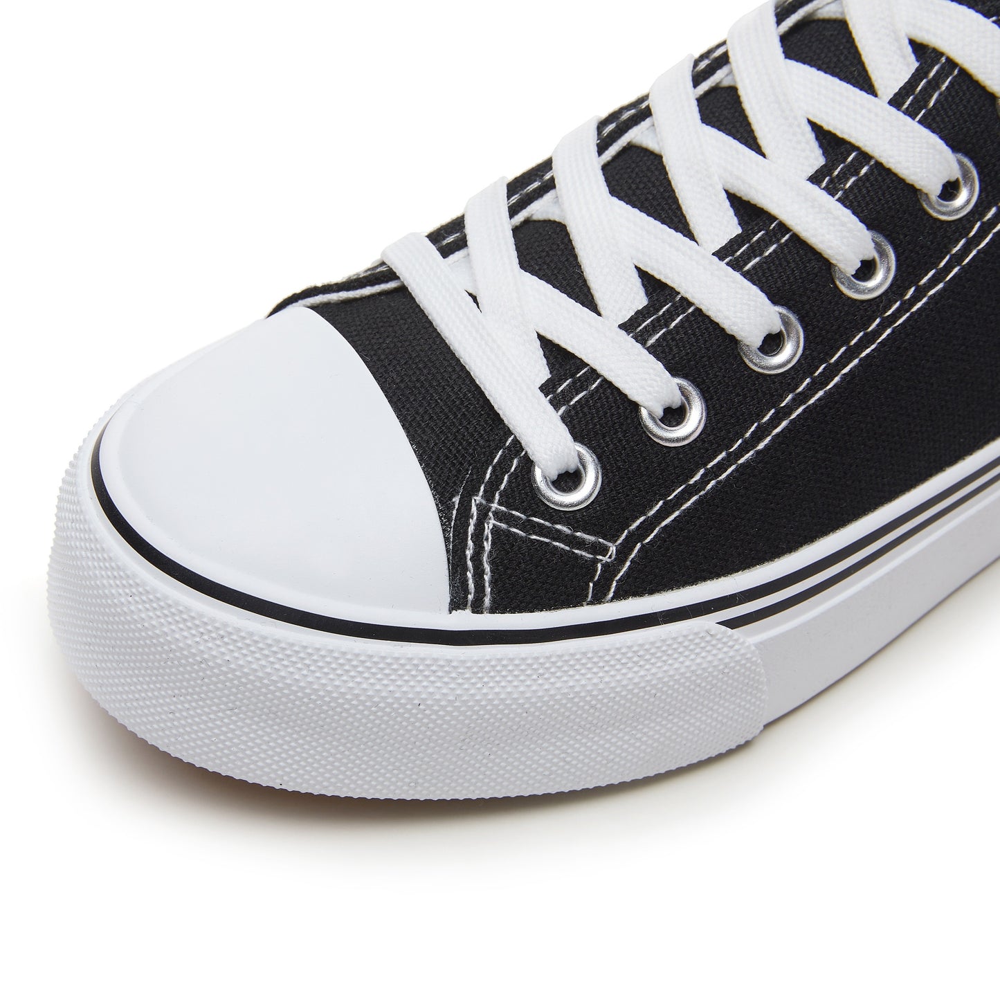 Black and white low top lace-up sneakers for women with rubber sole, fabric lining, and durable outsole for all-day comfort. Casual footwear with sleek design and fabric upper.