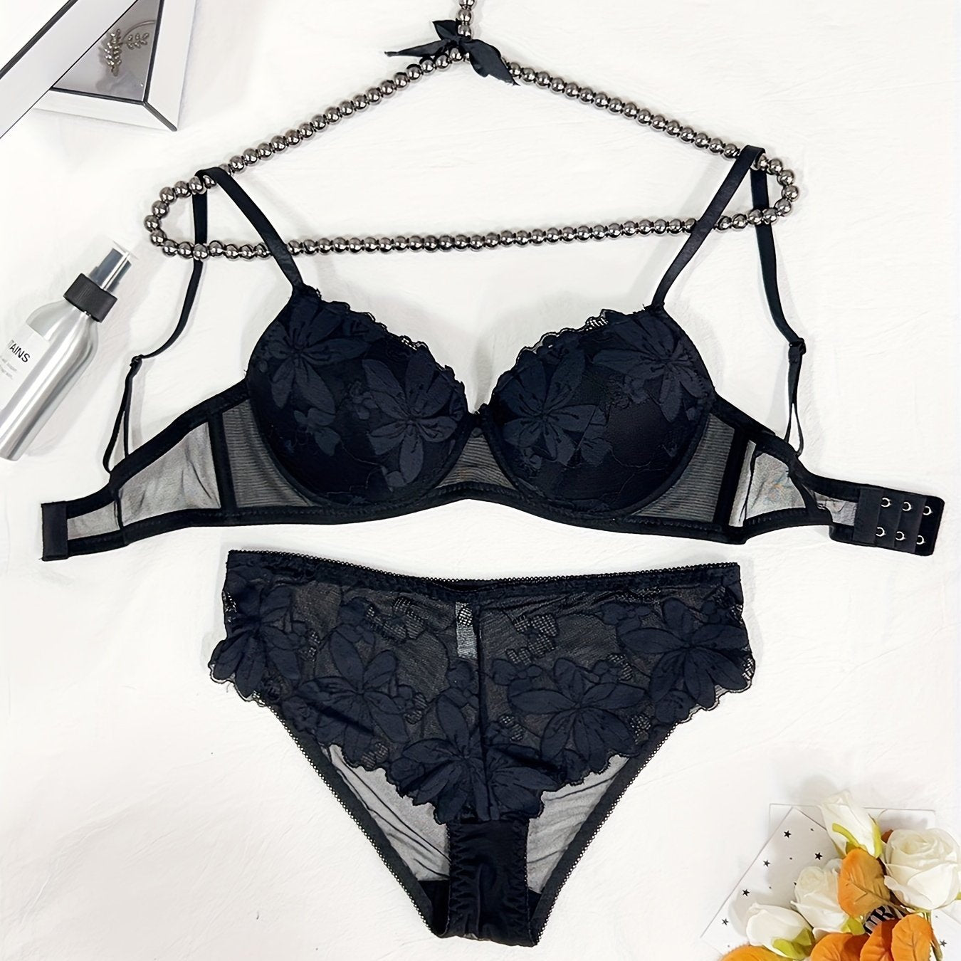 Floral embroidered lingerie set for women featuring a comfortable push-up bra, low-rise thong, mesh detail, and sexy triangle pant. Made with a nylon blend for breathability.