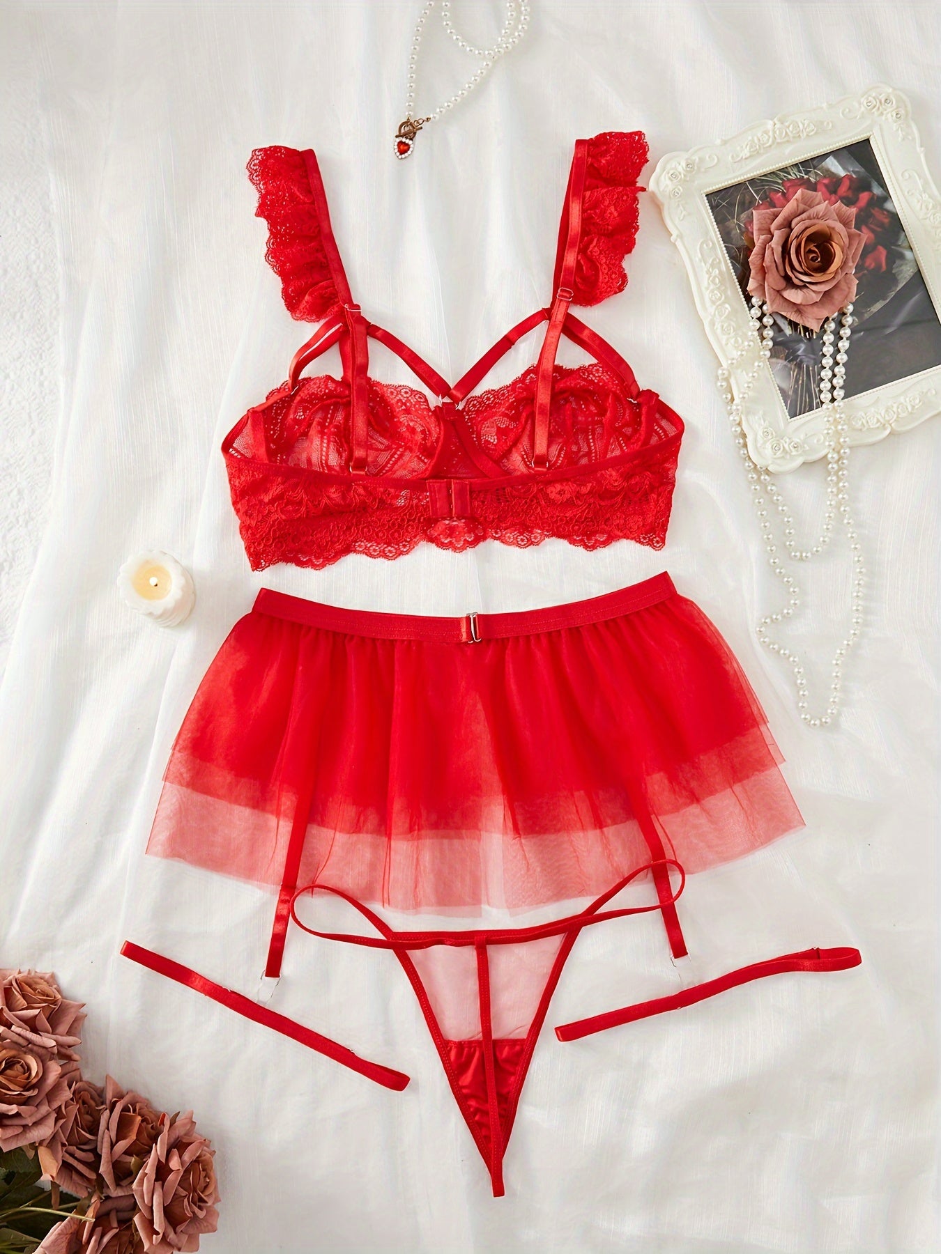 Red lace lingerie set with adjustable straps, mesh underwear, garter belt skirt, and leg garters, perfect for the bedroom.