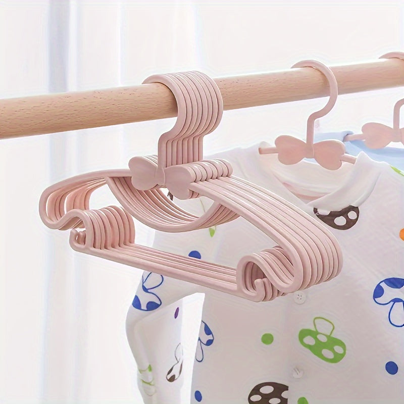 10-piece set of sturdy plastic hangers for kids' clothing - features anti-slip design and space-saving storage solution for children's wardrobes and dorm rooms.