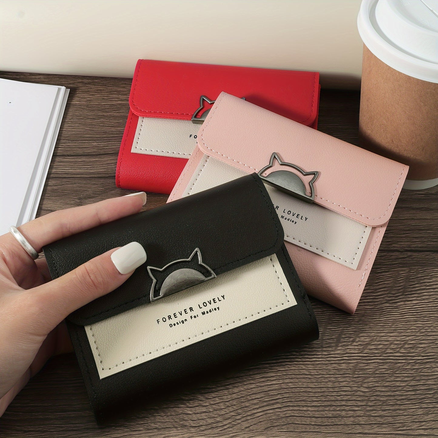 Compact folding wallet with cat metal decor, multiple card slots and coin pocket, available in red, pink, or black.