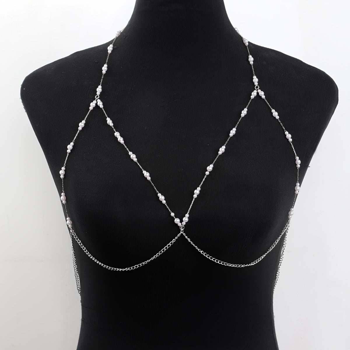 The woman personifies grace and refinement in a stunning body chain adorned with golden imitation pearls, ideal for adding a touch of glamour to any party or night out.