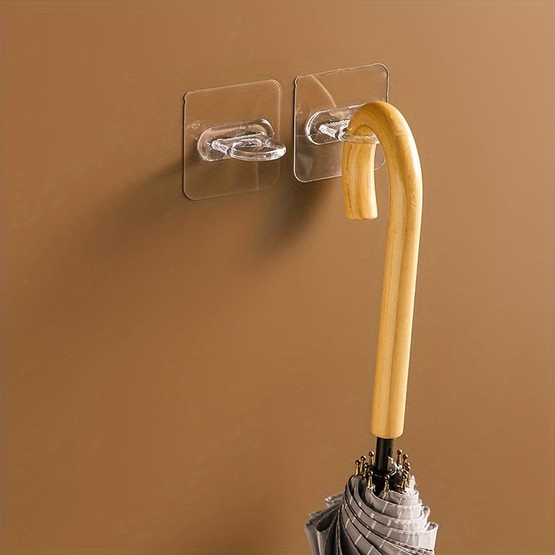 Set of 10 adhesive hooks for walls, ideal for bathroom and kitchen storage and organization.