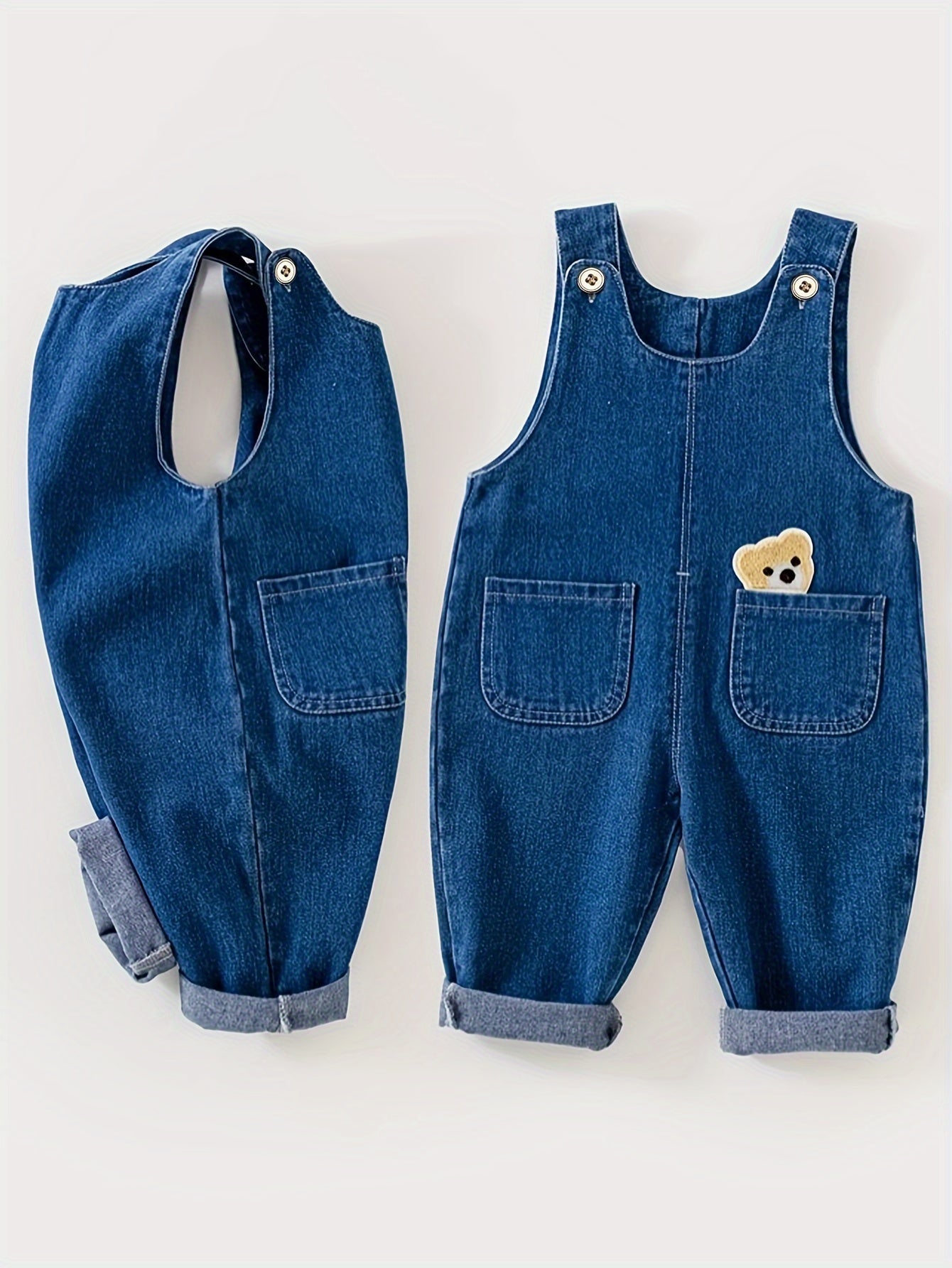 Children's denim overalls with animal pocket detail, made from a cotton blend fabric. Ideal for spring and fall seasons, this unisex toddler jeans romper is perfect for outdoor play.