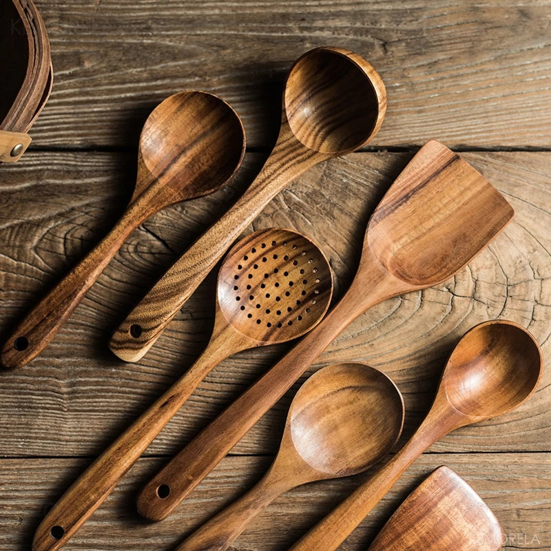 Set of 4/7 pieces of kitchen tools made from natural teak wood from Thailand, including spoons, ladles, turners, colanders, skimmers, and scoops, suitable for cooking and serving in the kitchen.