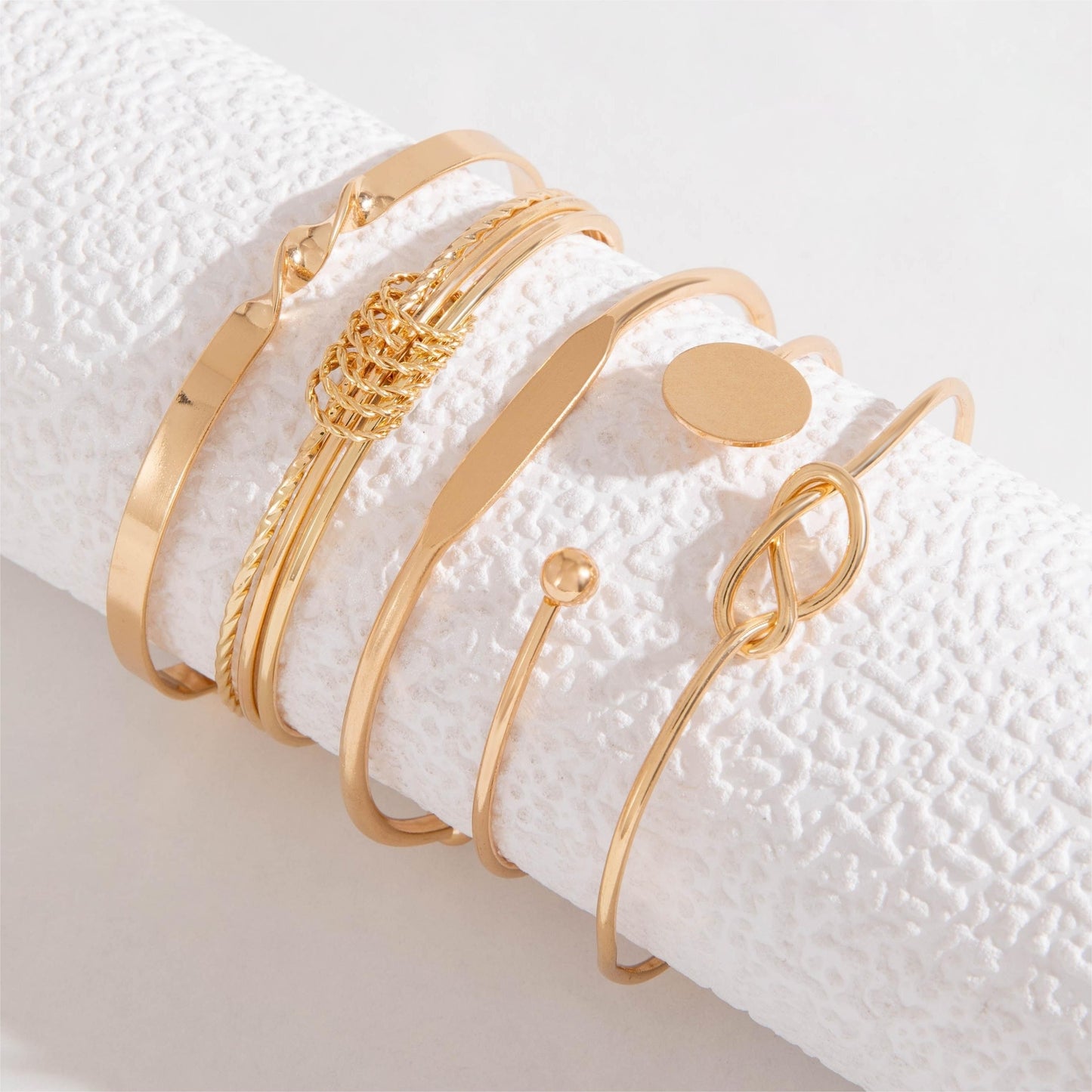 Set of 5 minimalist geometric alloy bangle bracelets for women in retro trendy style.