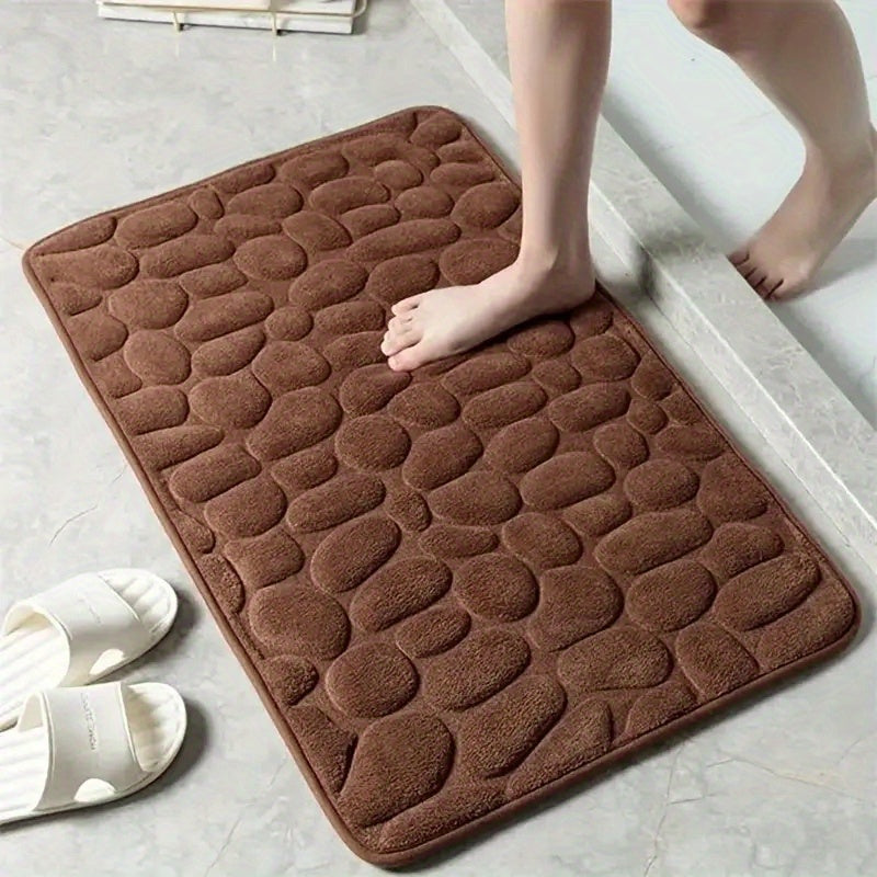 Soft, non-slip coral fleece bathroom mat in a pebble pattern. Quick-dry, machine washable, and low pile for comfort and home decor. Made of plush polyester fiber with knit fabric and 100% polyester material. 570gsm and 1.4cm thick.