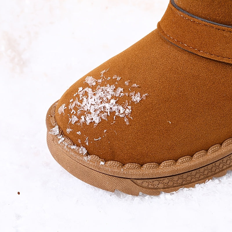 Children's winter boots with cozy fleece lining, warm and breathable, slip-on style with metal buckle straps, available in black and brown for boys and girls.