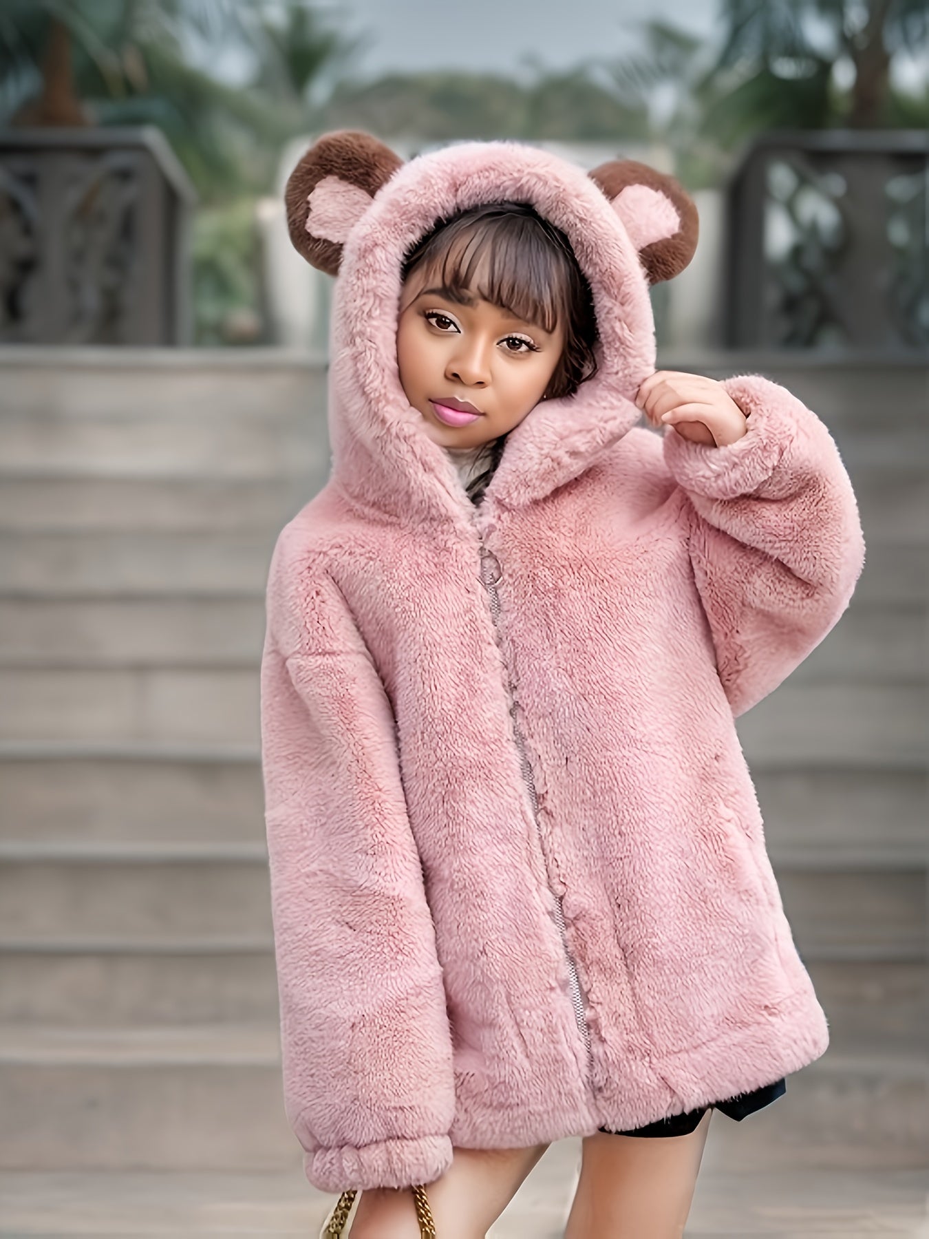 Kid's faux mink fur coat with bear ears hood for warmth in cold weather.